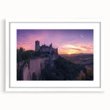 Framed landscape artwork showcasing a majestic castle surrounded by lush greenery, with a white mat for an elegant presentation, ideal for home decor.