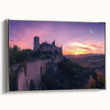 Framed canvas artwork depicting a serene landscape featuring a majestic castle set against a vibrant sunset, bordered with an elegant silver frame, ideal for enhancing home decor.