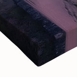 Close-up of a stretched canvas showcasing a vibrant landscape painting of a majestic castle surrounded by lush greenery and a clear blue sky, perfect for home decor.