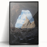Framed acrylic artwork showcasing a stunning landscape with caves, featuring a sleek black frame and vibrant colors, ideal for home or office decor.