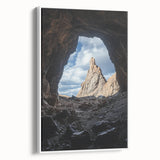 Framed canvas artwork depicting a serene landscape with caves, displayed from a side view against a white backdrop, enhancing modern home decor aesthetics.