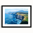 Black-framed landscape art print showcasing dramatic cliffs and serene skies, designed with a mat for an elegant presentation, ideal for home decor.