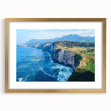 Elegant framed landscape art print showcasing dramatic cliffs and serene natural scenery, featuring a gold mat and frame, perfect for home decor enhancement.