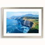 Framed landscape print showcasing rugged cliffs in a silver frame with a mat, ideal for modern home decor, emphasizing natural beauty and tranquility.