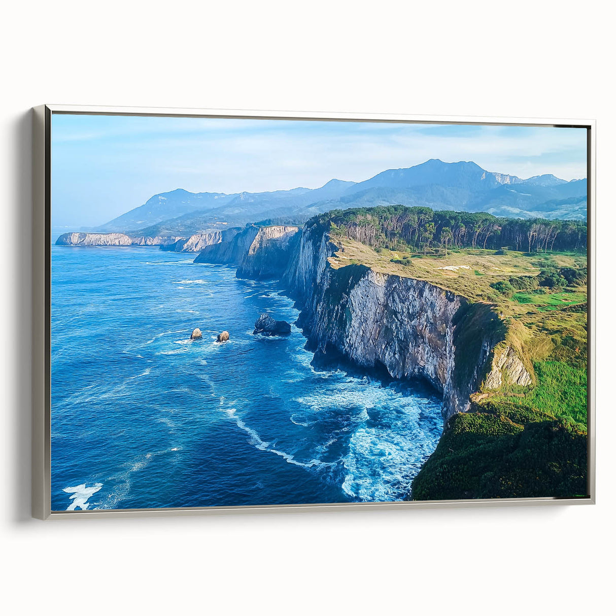 Framed canvas artwork depicting a stunning cliff landscape with vibrant colors and intricate details, featuring a sleek silver frame for an elegant presentation.