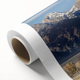 Rolled landscape canvas showcasing a rustic barn scene, featuring rich textures and earthy colors, elegantly packaged in a protective cardboard tube for safe delivery.