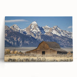 Stretched canvas artwork depicting a serene landscape with a rustic barn surrounded by lush greenery, perfect for enhancing home decor with a country charm.