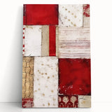 Abstract wall art featuring vibrant strokes in shades of blue, pink, and gold on a stretched canvas, leaning against a neutral wall, perfect for modern decor.