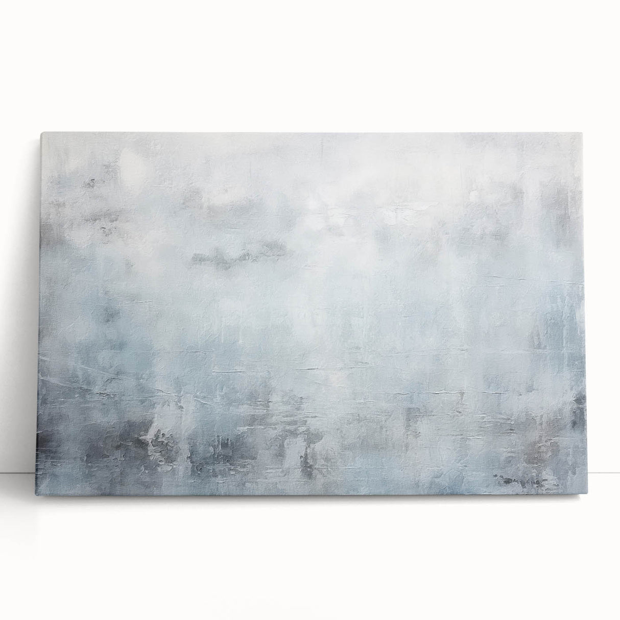 Abstract wall art featuring vibrant strokes in shades of blue, pink, and gold on a stretched canvas, leaning against a neutral wall, ideal for modern decor.