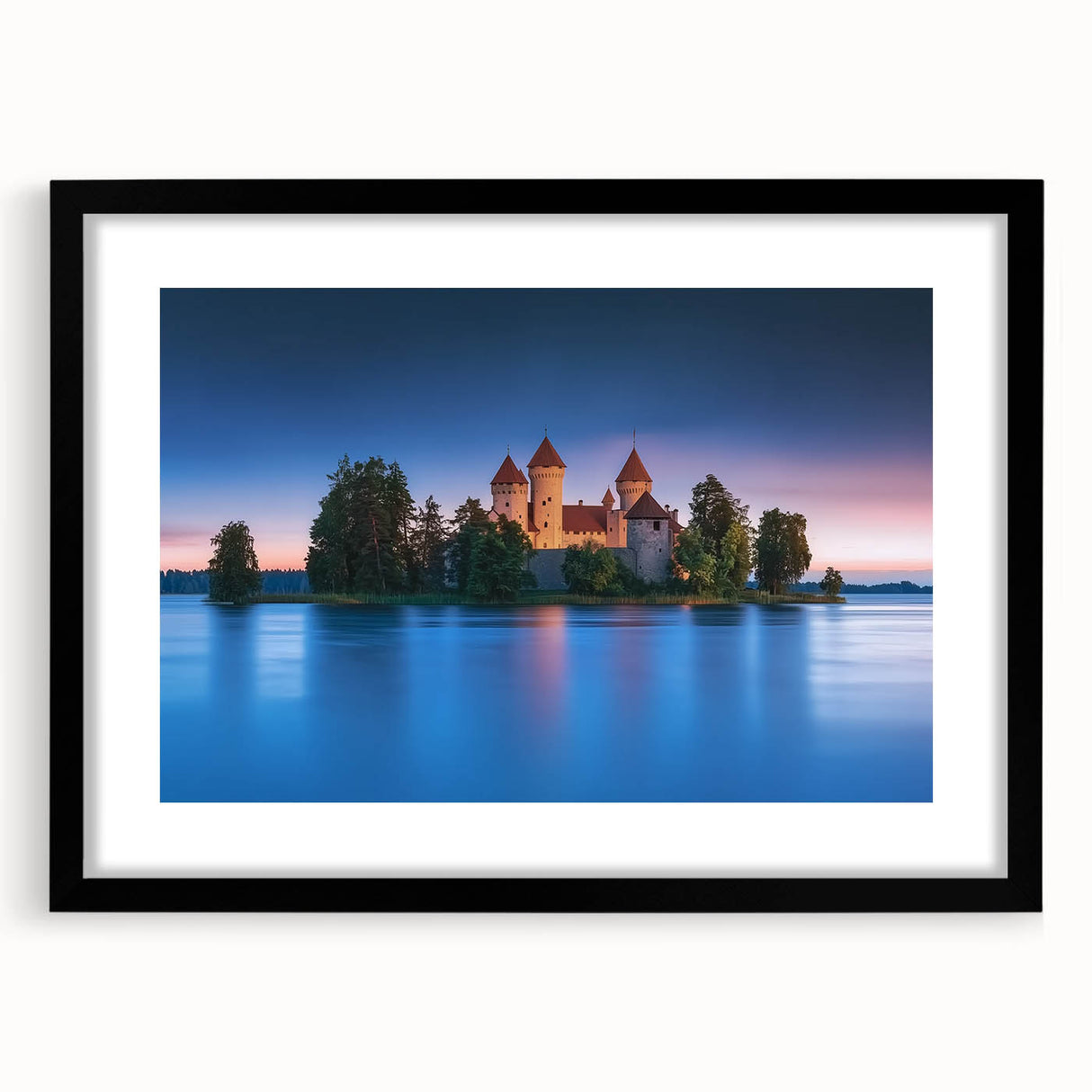 Elegant black-framed landscape artwork depicting a serene castle surrounded by lush greenery, featuring a white mat for added contrast, perfect for home decor.
