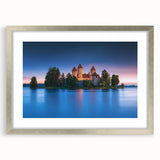 Framed landscape artwork depicting a serene castle scene, elegantly presented with a silver mat and frame, ideal for enhancing home decor.