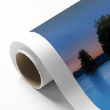 Rolled canvas artwork depicting a serene landscape featuring a majestic castle surrounded by lush greenery and a clear blue sky, elegantly packaged for safe delivery.