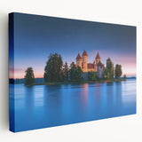 Stretched canvas artwork depicting a scenic landscape with a majestic castle surrounded by lush greenery and vibrant blue skies, perfect for home decor.