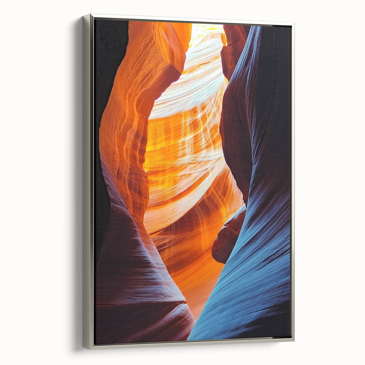 Framed canvas artwork depicting a serene landscape scene with intricate cave details and a silver frame, showcasing nature's beauty in a modern home setting.