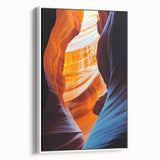 Framed canvas artwork showcasing an abstract landscape with intricate cave formations, displayed in a modern white frame, ideal for contemporary home decor.