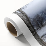 Rolled canvas showcasing a vibrant landscape design of a red barn surrounded by lush greenery, elegantly packaged in a durable cardboard tube for safe shipping.