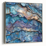 Framed canvas artwork depicting a stunning landscape of canyons in earthy tones, featuring a sleek silver frame that enhances the vibrant colors and intricate details.