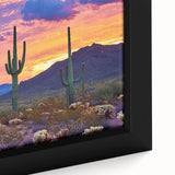 Close-up view of a framed desert landscape canvas print, showcasing vibrant orange and brown hues, intricate details of sand dunes, and a serene twilight sky, perfect for home decor.