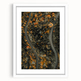 Abstract art print of autumn trees in orange and red tones, framed in white, ideal for dining room ambiance.