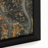Close-up of a framed canvas featuring textured black wall art with colorful autumnal leaves, ideal for living room decor.