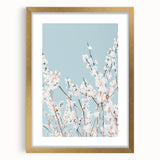 Abstract art print featuring textured swirls in pastel shades, framed in gold, ideal for living room decor.