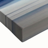 Close-up of an abstract strokes wall art design on stretched canvas, showcasing vibrant colors including blues, yellows, and reds, ideal for modern decor.