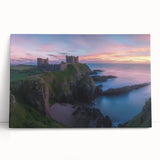 Stretched canvas artwork depicting a scenic landscape with a majestic castle surrounded by lush greenery and a clear blue sky, perfect for home decor.
