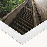 Rolled canvas artwork showcasing a vibrant landscape bridge design, featuring rich colors and intricate details, securely packaged in a protective cardboard tube for safe delivery.