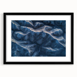 Framed desert landscape artwork with a black mat and frame, showcasing warm earth tones and intricate details, perfect for modern home decor.