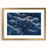 Desert landscape framed artwork with a gold mat, showcasing warm tones of sandy dunes and subtle blue skies, perfect for home decor or office spaces.