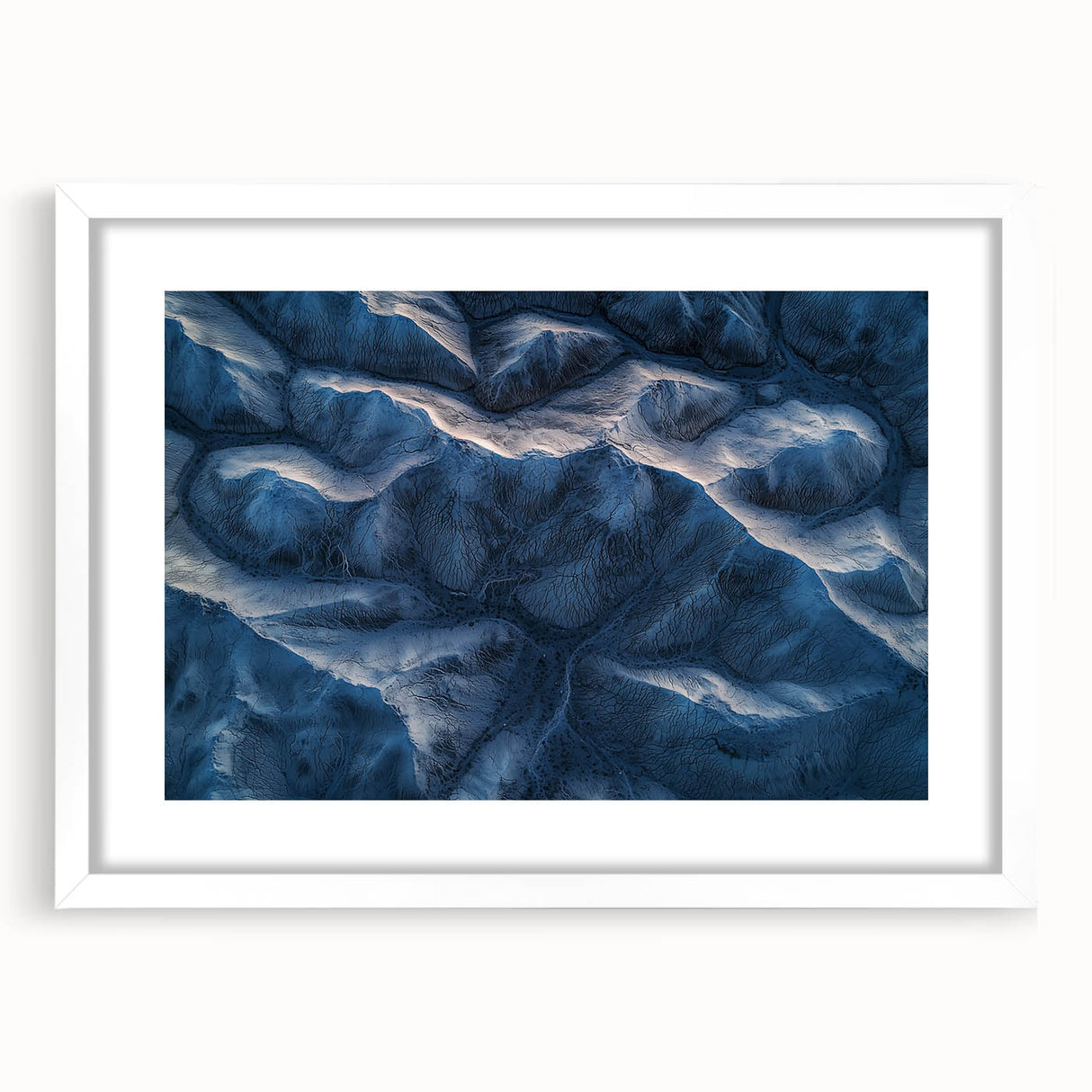 Desert landscape artwork in a white frame with a mat, showcasing vibrant colors and intricate details, perfect for enhancing home decor in contemporary settings.