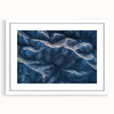 Desert landscape artwork in a white frame with a mat, showcasing vibrant colors and intricate details, perfect for enhancing home decor in contemporary settings.