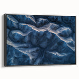 Framed canvas artwork depicting a serene desert landscape in warm tones of orange and brown, showcasing black framing and side view details for elegant display.