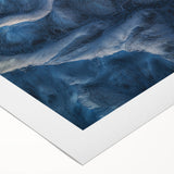 Rolled canvas artwork depicting a stunning desert landscape with vibrant colors and intricate details, securely packaged in a protective cardboard tube for transport.