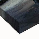 Close-up of a stretched canvas artwork depicting a scenic landscape with a majestic castle surrounded by lush greenery, ideal for home decor enthusiasts.