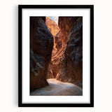 Framed landscape artwork depicting a serene cave scene, featuring rich earthy tones and a sleek black mat, perfect for enhancing modern home decor.