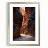 Framed landscape artwork depicting a serene cave scene with natural rock formations, showcased in a sleek silver frame with a white mat, perfect for home decor.