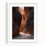 Framed landscape artwork showcasing a serene cave scene, featuring earthy tones and intricate details, with a white mat enhancing its visual appeal.