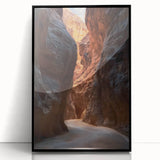 Framed acrylic artwork showcasing a stunning landscape scene with caves, featuring a sleek black frame and a modern aesthetic, perfect for home decor.