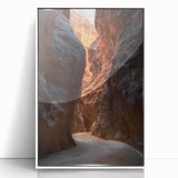 Framed acrylic artwork depicting a serene landscape with caves, featuring vibrant colors and intricate details, set against a sleek white frame for modern decor.