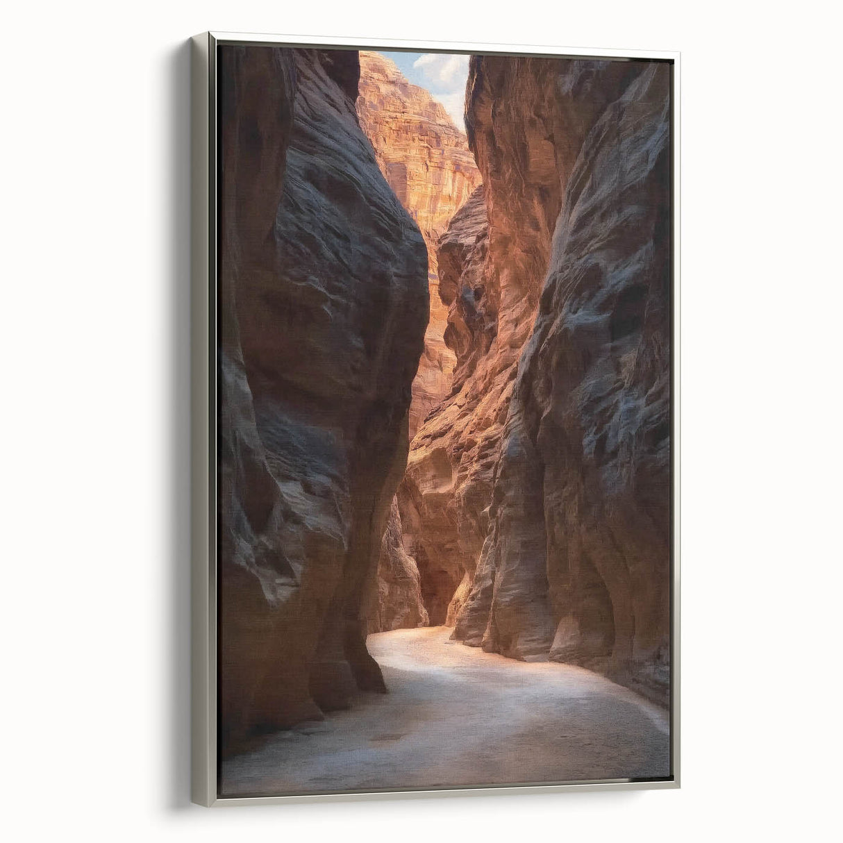 Framed canvas artwork showcasing an intricate landscape scene with caves, featuring a silver frame and side view perspective, perfect for home décor.