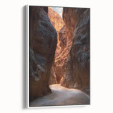 Framed canvas artwork depicting a serene landscape with caves, featuring earth tones and a white frame, ideal for enhancing modern home decor.
