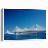 Framed canvas artwork depicting a serene landscape bridge scene, featuring lush greenery and a tranquil waterway, presented in a white frame for modern decor appeal. This piece adds a touch of nature-inspired elegance to any room.