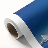 Rolled canvas artwork showcasing a vibrant landscape of a bridge, featuring rich colors and intricate details, securely packaged in a protective cardboard tube for easy transport and display.