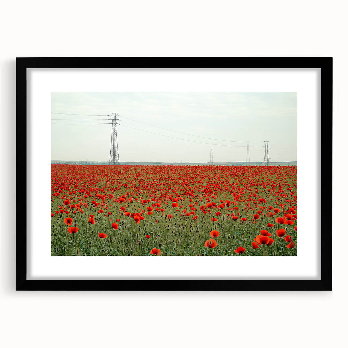 Black-framed landscape artwork showcasing a serene countryside scene with vibrant greenery and rolling hills, designed to enhance home decor aesthetics.