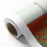 Rolled canvas artwork showcasing a serene countryside landscape, featuring vibrant green fields and a clear blue sky, packaged securely in a cardboard tube for safe delivery.