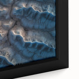 Close-up of a framed desert landscape canvas, showcasing vibrant orange and yellow hues with intricate details of sand dunes and textured brush strokes. Ideal for modern home decor.