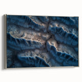 Framed canvas artwork depicting a stunning desert landscape, featuring warm earthy tones and intricate details, displayed with a sleek silver frame for a modern touch.