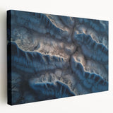 Stretched canvas artwork depicting a vibrant desert landscape in warm hues of orange and yellow, showcasing cacti against a dramatic sunset sky, ideal for modern home decor.