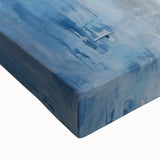 Close-up view of vibrant abstract strokes wall art on stretched canvas, showcasing bold colors of blue, orange, and yellow, perfect for modern decor.